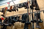 Boots for costumes hang in rows in the Oregon Shakespeare Festival warehouse in Talent, Ore., in this undated provided image.