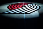 The Portland Trail Blazers logo is displayed at half court before a preseason NBA basketball game against the Golden State Warriors on Wednesday, Oct. 7, 2026, in Portland, Ore.