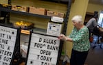Volunteer Karen Winterstein packs up signs as the food bank closes.