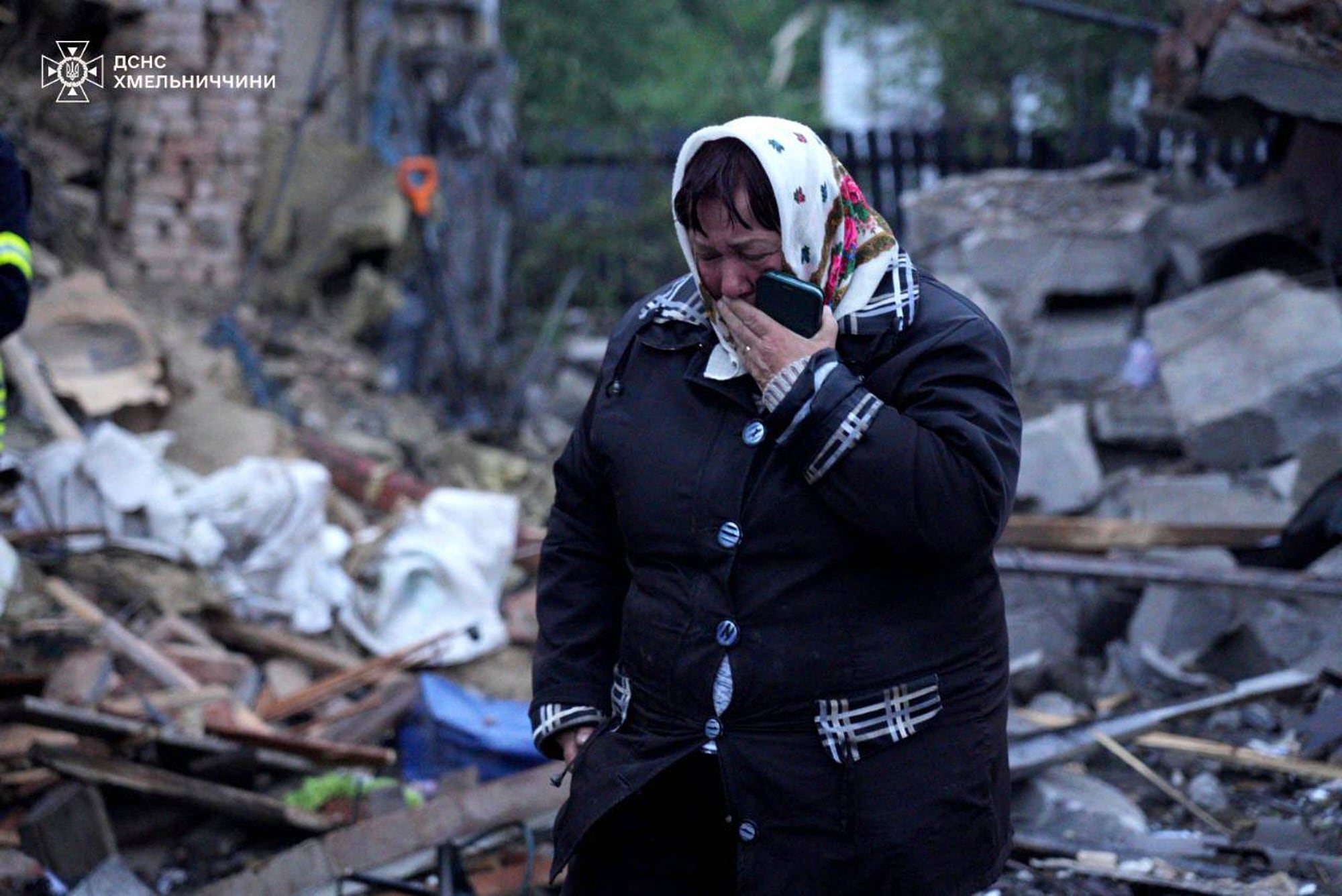 In this photo provided by the Ukrainian Emergency Service, a local resident cries standing amid the rubble of her house ruined after Russia's air attack in Khmelnytskyi region, Ukraine, Sunday, May 25, 2025.