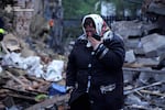 In this photo provided by the Ukrainian Emergency Service, a local resident cries standing amid the rubble of her house ruined after Russia's air attack in Khmelnytskyi region, Ukraine, Sunday, May 25, 2025.