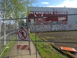 The sidewalk is closed in front of the building that formerly housed Interstate Lanes