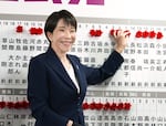 Sanae Takaichi, Japan's prime minister and president of the ruling Liberal Democratic Party (LDP), puts pins marking the names of candidates who won lower house elections at the LDP headquarters Sunday, Feb. 8, 2026 in Tokyo. 