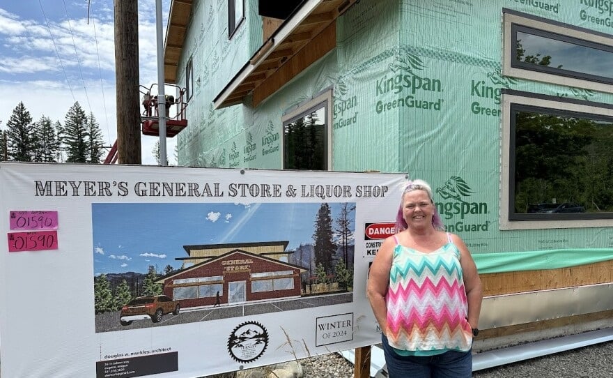 Melanie Stanley, owner of Meyer's General Store and Liquor Shop, stands next to the new one being rebuilt after the previous one was destroyed in the Holiday Farm Fire. Stanley says it's been difficult getting loans and other support, and knows other proprietors who also are struggling.