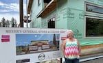 Melanie Stanley, owner of Meyer's General Store and Liquor Shop, stands next to the new one being rebuilt after the previous one was destroyed in the Holiday Farm Fire. Stanley says it's been difficult getting loans and other support, and knows other proprietors who also are struggling.