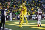 Oregon tight end Terrance Ferguson (19), left, celebrates his touchdown with Oregon tight end Moliki Matavao (8) during the third quarter of an NCAA college football game against Stony Brook Saturday, Sept. 18, 2021, in Eugene, Ore.