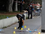 An Israeli Police officer works at the site of a stabbing attack that, Israeli police said, a Palestinian attacked killed a woman and wounded a few others, in Holon, Israel, on Sunday.