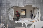 Officers from Israel's Home Front Command inspect a house destroyed by an Iranian missile strike in Zarzir, northern Israel, Friday, March 13, 2026.