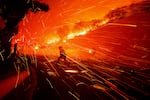 Firefighters battle the Franklin Fire in Malibu, Calif., on Tuesday, Dec. 10, 2024.