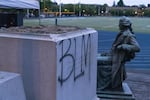 The Thomas Jefferson statue sits next to its at Jefferson High School in Northeast Portland after protesters tore it down after a Black Lives Matter rally.