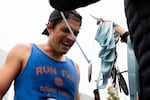 Nathan Freeburg of Portland, Oregon, receives his half marathon medal at the finish line.