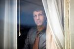 Joe Dibee looks out of a window at his family's home on Wednesday, February 17, 2021, in Seattle.