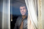 Joe Dibee looks out of a window at his family's home on Wednesday, February 17, 2021, in Seattle.