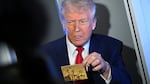 President Donald Trump holds up the $5 million gold card as he speaks to reporters while in flight on board Air Force One, en route to Miami, Thursday, April 3, 2025.