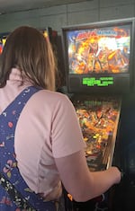 A Belles & Chimes Eugene member plays a machine called "Medieval Madness."