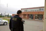 A Portland Police Bureau school resource officer stands outside of a Portland Public Schools high school.