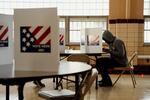 Adam Powell, 45, casts his ballot during the General Election at Holy Name Community Center in Bellefontaine Neighbors, Mo. A power outage at the polling site caused staff to run off of lanterns and generators.