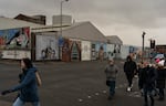 People walk by fresh murals in support of Palestinians at what's known as the International Wall or Solidarity Wall on the Falls Road in West Belfast, a prominently Catholic and Irish nationalist area of Northern Ireland, on Feb. 9.