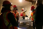 A volunteer team checks a mock apartment for injured people.