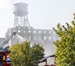 Firefighters and other emergency personnel monitor and battle a fire at a vacant warehouse in Northwest Portland, Ore., on Aug. 2, 2026.