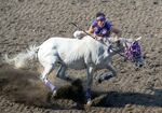 Ryder Abrahamson of the Abrahamson team, dismounts his horse on the fly in the exchange zone during the relay.