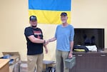 In this undated supplied photo, Ashland resident Ben Stott, right, establishing a sister city agreement with Volodymyr Ribalkin, the mayor of Sviatohirsk, Ukraine.