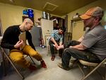 Gabriel Ledger, left, and Yu Matsumoto, middle, assess Danny Wheeler's ankle at the Farm Clinic.