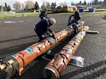 In this Feb. 24, 2021 photo NATIVES master carver Vic Hansen and two assistants ready two finished totem poles for delivery to North Eugene High School and Madison Middle School.