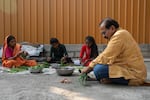 Shahu Patole sorts and cuts greens with family members in Khamgaon, India on November 11, 2024. Maya Levin for NPR