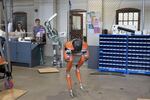 Students watch as the robot Cassie stands up in the Dynamic Robotics Laboratory at Oregon State University.