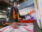 Orion Meyer sorts ballots at the Multnomah County Elections Division in Portland, Ore., Nov. 8, 2022. Multnomah County voters were overwhelmingly in favor of Measure 114, which will tighten gun laws in the state.