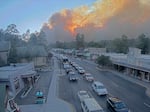 In this image taken from webcam footage provided by the Village of Ruidoso, smoke rises behind Ruidoso, N.M., on Monday.