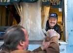Taiki Nakajima, owner of Tokyo Sando food truck in downtown Portland, Ore., serves a box of Miso Katsu Sando sandwich to customer David Conklin on Nov. 27, 2023. The beloved food truck selling Japanese-style sandwiches is set to close on Sunday.