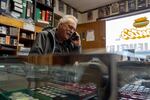 Monte Mensing, owner of Monte’s Coins and More, laughs as he talks with a customer on the phone in the Stayton, Ore., shop on Jan. 14, 2026.