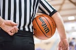 A referee holds the ball in the quarterfinals of the OSAA 6A Boys Basketball Championships between Grant High School and West Salem High School at the Chiles Center in Portland, Oregon, Thursday, March 8, 2018.