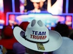 An attendee wears a "Team Trump" cowboy hat as people watch speakers during Turning Point's "Peoples Convention" on Saturday in Detroit. 