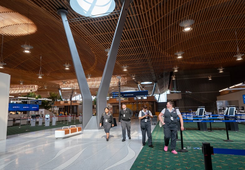 Airline staff walk through the new main terminal at the Portland International Airport, Aug. 2, 2024. The next milestone in the $2.15 billion expansion will happen on Aug. 14, when the new main terminal will be opened to the public.