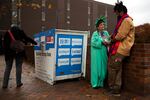 Patti Gorman, dressed as lady liberty, talks with her former Seattle Central student, Afrikaan Sahra, right, as voters cast their ballots outside of Seattle Central College in Capitol Hill. Sahra is voting for the first time after receiving U.S. citizenship.