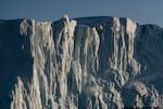 The sunset reflects off of an iceberg in Ilulissat.