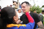 Andry Hernandez greets his best friend Reina Cardenas, after police drop him off at home on July 23, 2025.
