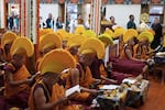 Exiled Tibetans carry ceremonial offerings as Tibetan Buddhist monks in ceremonial hats pray for the longevity of their spiritual leader the Dalai Lama in Dharamshala, India on June 4, 2025.