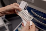 A nurse displays a set of birth control pills at Pima County Health Department's Northwest Clinic, which offers free reproductive health services for all ages through federal funding from Title X, in Tucson, Arizona, on Thursday, September 3, 2026.