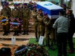 Israeli soldiers carry the flag-draped casket of Staff Sgt. Birhanu Kassie during his funeral at Mt. Herzl military cemetery in Jerusalem, Sunday, Dec. 24, 2023.