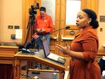 Michele Watley, founder of Shirley's Kitchen Cabinet, testifies in favor of a bill before the Kansas Legislature to ban discrimination based on hairstyles in employment, housing and public accommodations during a committee hearing, Tuesday, Jan. 28, 2020, at the Statehouse in Topeka, Kan.