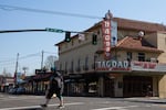 A man crosses the street in front of the Bagdad, a theater owned by McMenamins, in Portland, Ore., Thursday, March 19, 2020. McMenamins laid off some 3,000 employees after the large gatherings ban and statewide bar and restaurant closure.