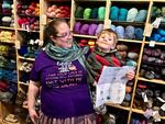 Laura Walthinsen of Portland and her son Aidan, 3, received her 11th and final 2018 Rose City Yarn Crawl passport stamp at the Knitting Bee in deep Southwest Portland. The Bee was her sixth and last stop on her third day, qualifying her for the event’s randomly selected grand prizes.  