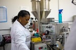 Hue Noir founder, CEO and head chemist Paula Hayes packaging a fresh batch of "Hot Chocolate" foundation at her Beaverton, Oregon lab on May 24, 2019.