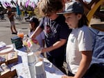 (From left) Vera Dobbs, 7, Jack Gavin, 10, and Cayden Dobbs, 10, work a lemonade and chocolate-chip cookie fundraiser stand for Silver Rail families on Sunday, Oct. 18, 2026 in Bend, Ore.