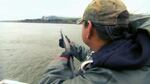 A Columbia River Inter-Tribal Fish Commission worker hazes sea lions with noise makers from a shotgun.