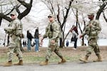 Members of the National Guard patrol the Tidal Basin as tourists visit the Cherry Blossoms on March 30, 2026 in Washington, DC.